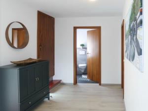 a bathroom with a green dresser and a toilet at Apartment Nürburgblick by Interhome in Quiddelbach