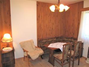 a dining room with a table and chairs and a lamp at Holiday Home Spinka by Interhome in Červený Kostelec