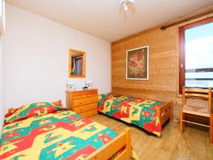 a bedroom with two twin beds and a window at Apartment Le Curling A - Val Claret-17 by Interhome in Tignes +8 photos