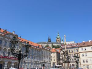 a city street with buildings and a castle in the background at Apartment Nerudova by Interhome in Prague