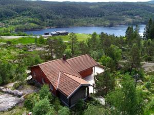 a house on top of a hill with a lake at Chalet Eikebu - SOW137 by Interhome in Fossdal