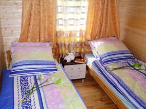 a bedroom with two beds and a window at Holiday Home Onyx-1 by Interhome in Mielno