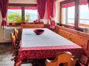 a table with a bowl on it in a room with windows at Apartment Cà Mia by Interhome in Dosso del Liro