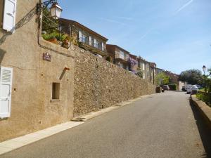 una strada vuota accanto a un muro di pietra di Studio Gassin Village by Interhome a Gassin