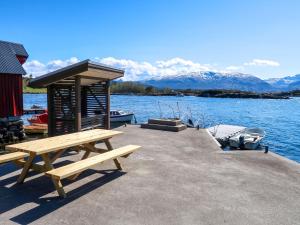 a picnic table on a dock next to the water at Holiday Home Svortevik - FJS077 by Interhome in Førde