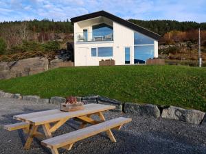 a picnic table in front of a house at Holiday Home Svortevik - FJS077 by Interhome in Førde