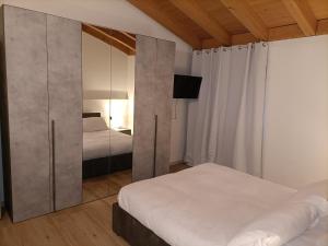 1 dormitorio con 2 camas y armario grande en B&B in Fattoria, en Berzo San Fermo