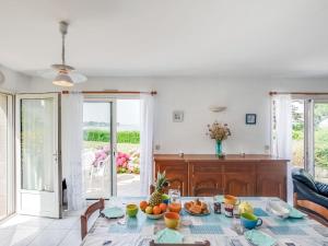 a dining room with a table with fruit on it at Holiday Home Maison Poul by Interhome in Saint-Pierre-Quiberon