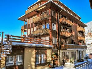 an apartment building with balconies on the side of it at Apartment Schweizerhof-1 by Interhome in Wengen