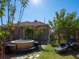 a garden with a tub and a bench and a fence at Apartment Angolo di Sole by Interhome in Poggio