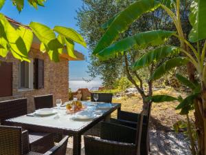 a table on the patio with a view of the ocean at Apartment Angolo di Sole by Interhome in Poggio