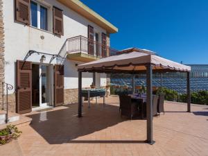 a patio with a table and an umbrella at Apartment Angolo di Sole by Interhome in Poggio +20 photos
