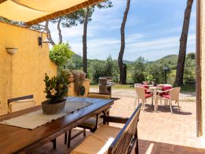an outdoor patio with a wooden table and chairs at Apartment Saha by Interhome in Sperlonga