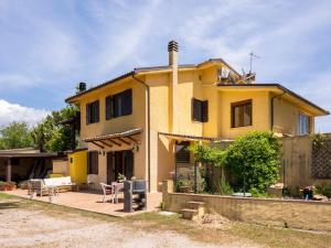 a yellow house with a patio in front of it at Apartment Saha by Interhome in Sperlonga