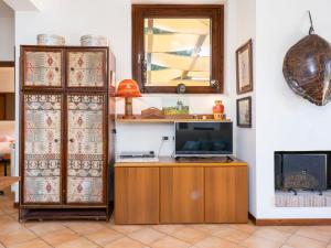 a living room with a tv and a mirror at Apartment Saha by Interhome in Sperlonga