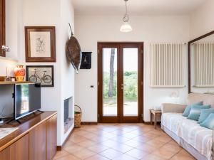 a living room with a couch and a tv at Apartment Saha by Interhome in Sperlonga