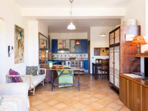 a kitchen and living room with a table and chairs at Apartment Saha by Interhome in Sperlonga +39 photos