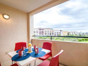 a room with a table and chairs and a large window at Apartment Les Marines-36 by Interhome in La Foux