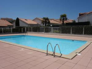 a large swimming pool with two metal bars in it at Holiday Home Les Jardins de l'Océan-38 by Interhome in Pontaillac