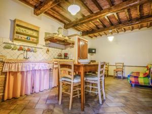 a kitchen with a wooden table and chairs at Apartment Podere La Torre-2 by Interhome in Certaldo