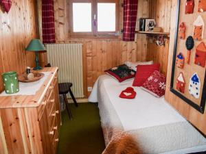 a small bedroom with a bed and a sink at Apartment Fury by Interhome in Verbier