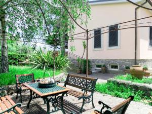 a patio with a table and benches in a yard at Apartment Amalasunta by Interhome in Marta