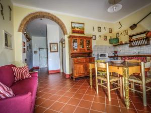 a living room with a table and a kitchen at Apartment Podere La Torre-1 by Interhome in Certaldo