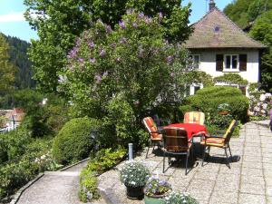 a patio with a table and chairs in front of a house at Apartment Maier-2 by Interhome in Triberg