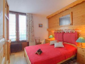 a bedroom with a red bed with a red blanket at Apartment Grandes Platières II-2 by Interhome in Tignes