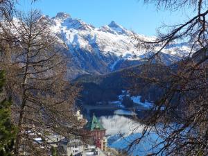 a view of a mountain with a town and a lake at Apartment Chesa Cripels I by Interhome in St. Moritz