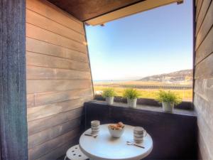 a small room with a table and a window at Studio Les Marinas-10 by Interhome in Deauville