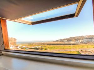 a window with a view of the beach at Studio Les Marinas-10 by Interhome in Deauville