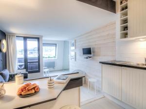 a kitchen with a counter top and a table in a room at Studio Les Marinas-10 by Interhome in Deauville