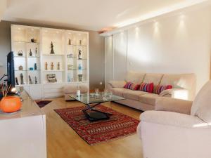 a living room with a couch and a table at Apartment Elisa-2 by Interhome in Trouville-sur-Mer