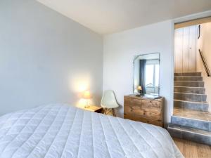 a bedroom with a large white bed and a mirror at Apartment Les Marinas-3 by Interhome in Deauville