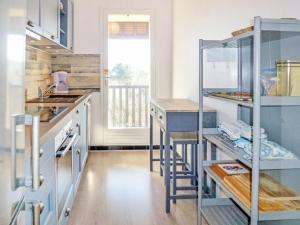 a kitchen with blue cabinets and a counter top at Apartment Eden Park by Interhome in Bénerville-sur-Mer +13 photos