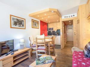 a living room with a table and a kitchen at Studio Les Tommeuses - Val Claret-31 by Interhome in Tignes