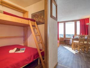 a bedroom with a bunk bed and a dining room at Apartment Les Grandes Platières-22 by Interhome in Tignes