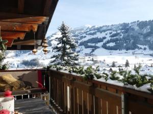 a balcony with a view of a snow covered mountain at Apartment Kristall by Interhome in Zweisimmen