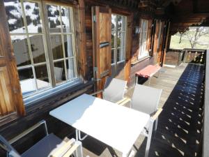 a table and chairs on the porch of a cabin at Apartment Guex by Interhome in Hornkessel