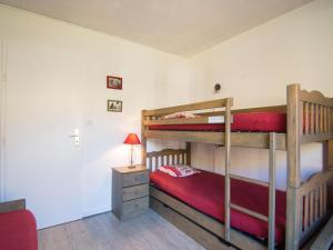 a bedroom with two bunk beds and a table with a lamp at Apartment Le Curling B-38 by Interhome in Tignes