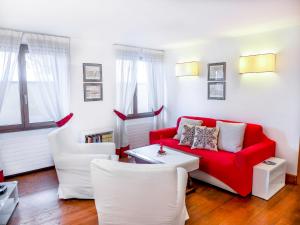 a living room with a red couch and white chairs at Apartment Chesa Sonnalpine B 52 by Interhome in St. Moritz
