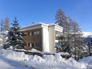 a building with snow in front of it at Apartment Chesa Cripels II by Interhome in St. Moritz