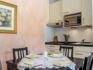 a dining room with a table and chairs and a kitchen at Apartment Village Marin-16 by Interhome in La Foux