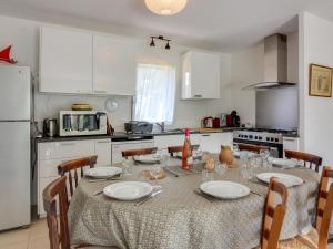 a kitchen with a table with plates and glasses on it at Holiday Home Ker-Heol by Interhome in Port Blanc