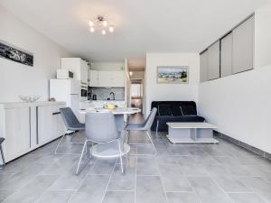 a kitchen and a living room with a table and chairs at Apartment Les Marinas de la Plage I-3 by Interhome in Le Grau-du-Roi