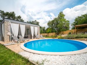 a swimming pool in the backyard of a house at Holiday Home Ofelia by Interhome in Buroli