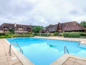 an image of a swimming pool in front of a house at Holiday Home Domaine de Clairefontaine-2 by Interhome in Deauville +28 photos