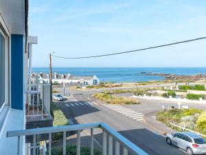 a balcony with a view of a road and the ocean at Studio Les Brisants by Interhome in Kervoz
