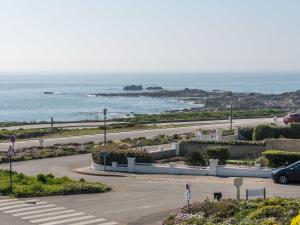 a parking lot with the ocean in the background at Studio Les Brisants by Interhome in Kervoz
